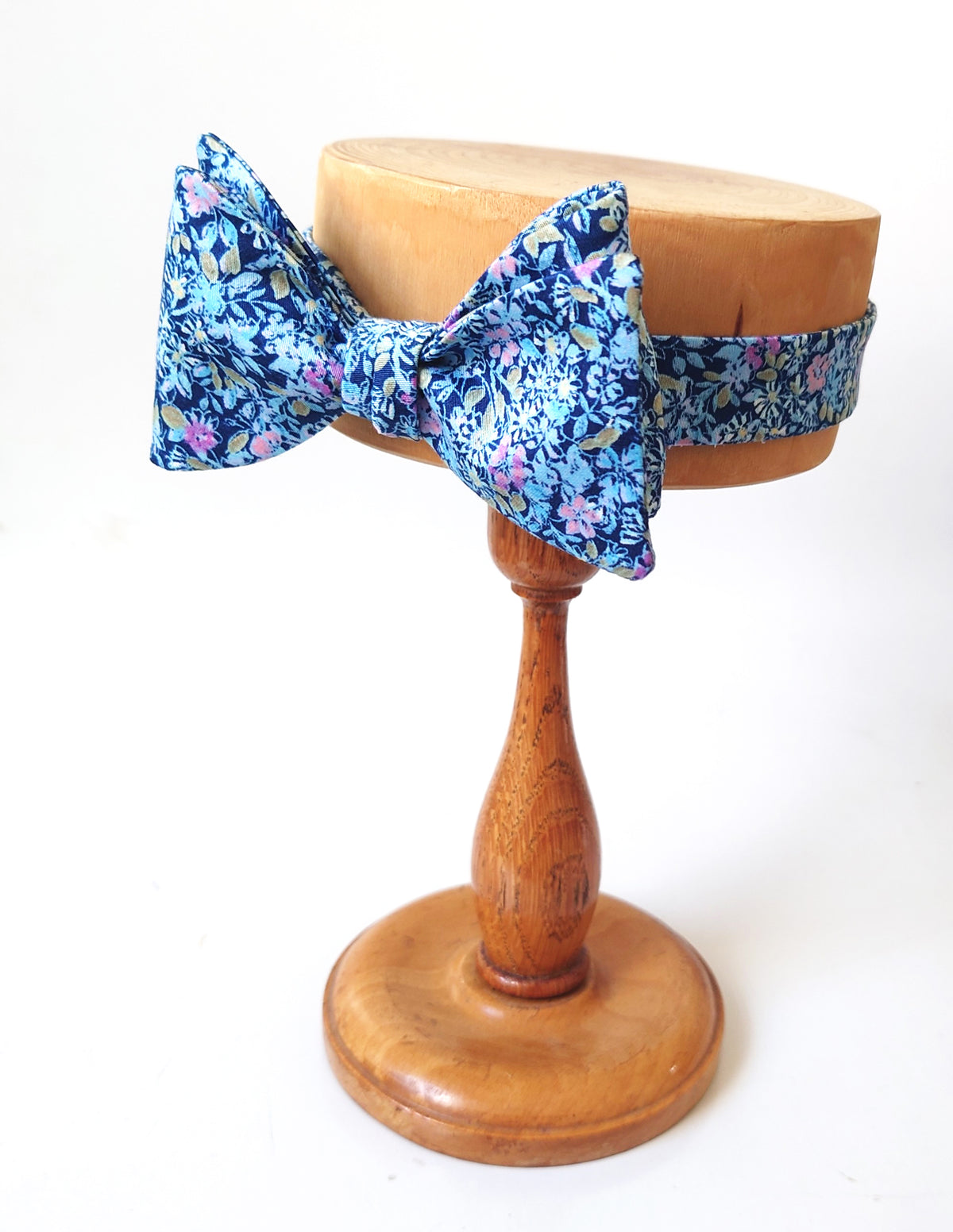 A sky blue bow tie with pink accents