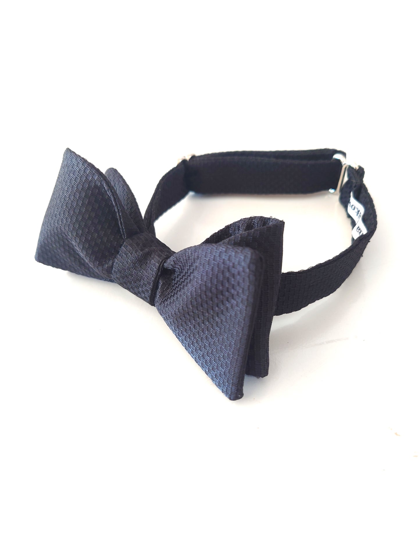 Classic vintage textured silk bow tie on a white background