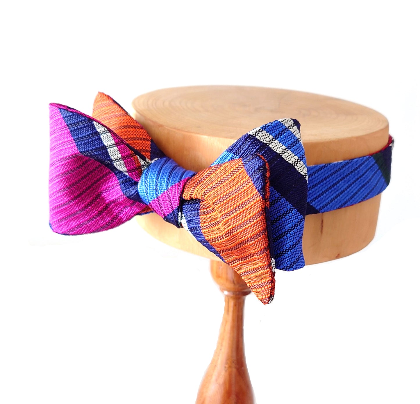 colourful silk bow tie on a display by Lewes Bow Ties