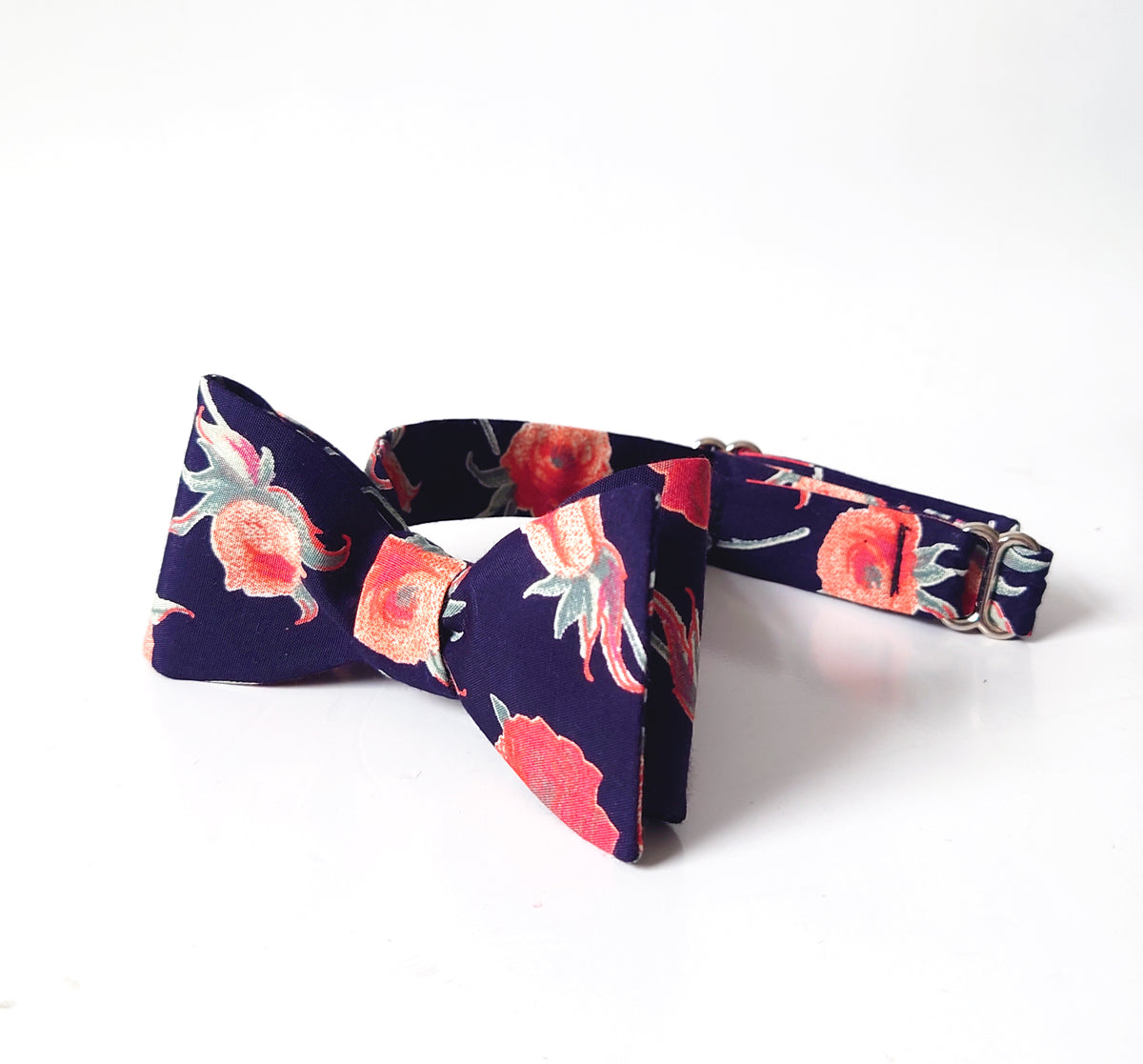 Peach roses on navy blue bow tie
