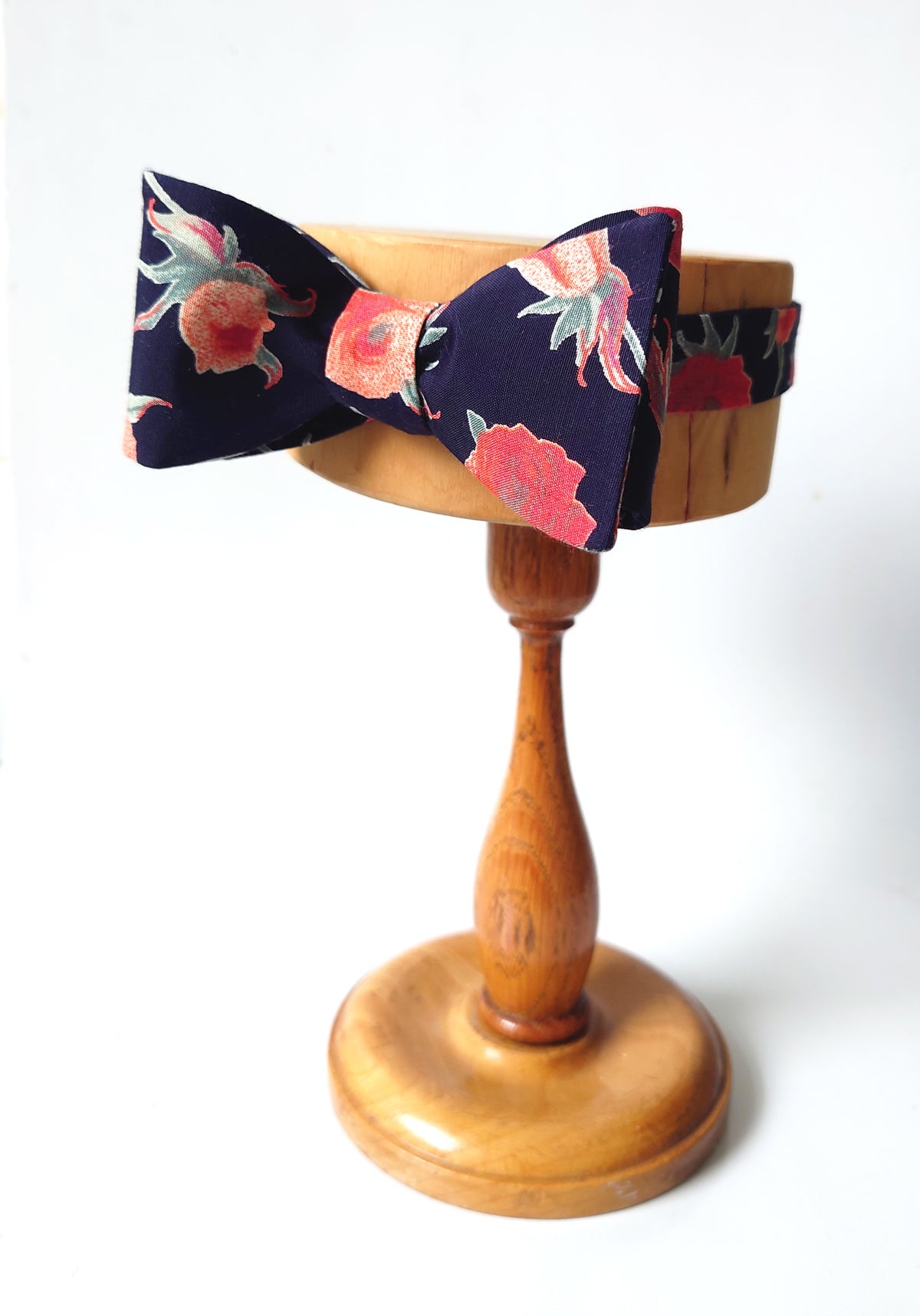 Peach roses on navy bow tie hand crafted from cotton and silk 