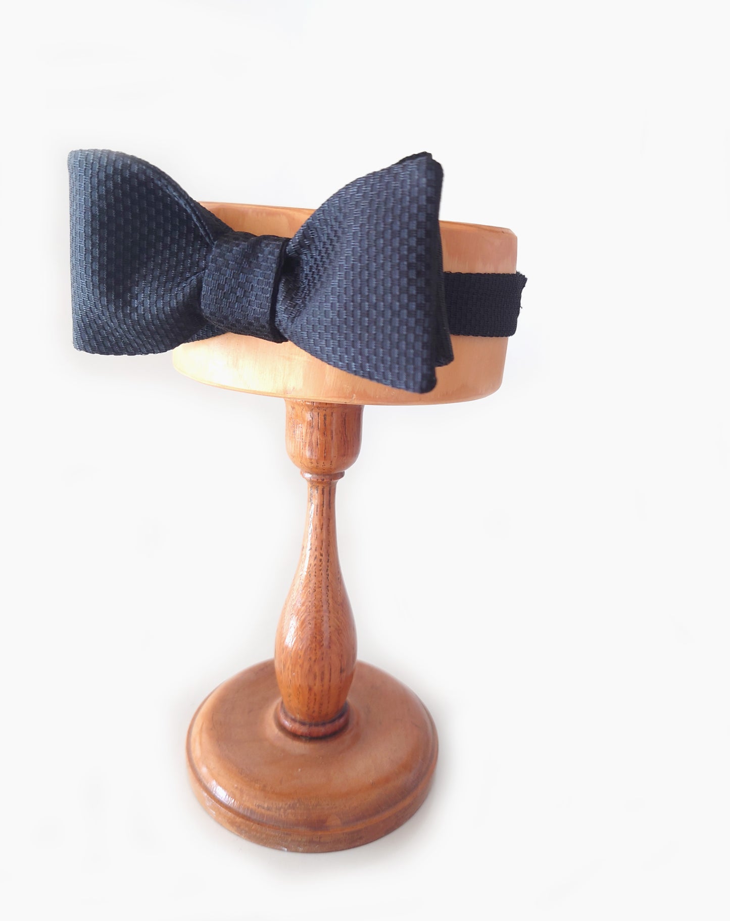  Black textured silk bow tie on a display stand by Lewes Bow Ties