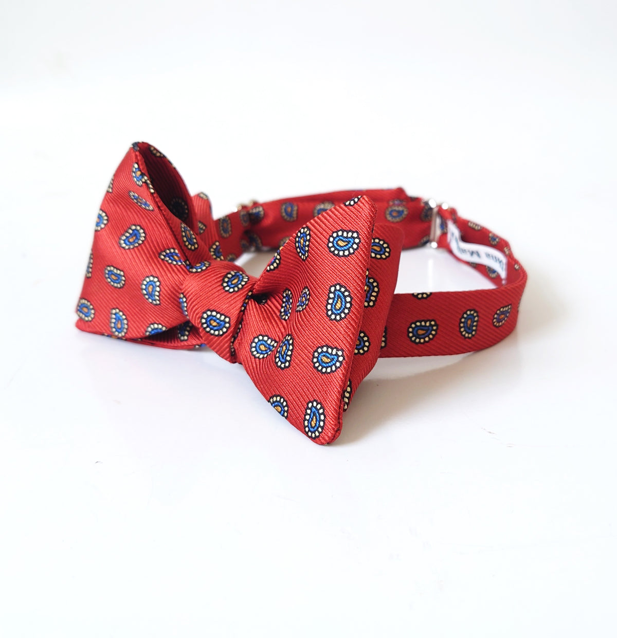 a burnt orange and navy paisley silk bow tie